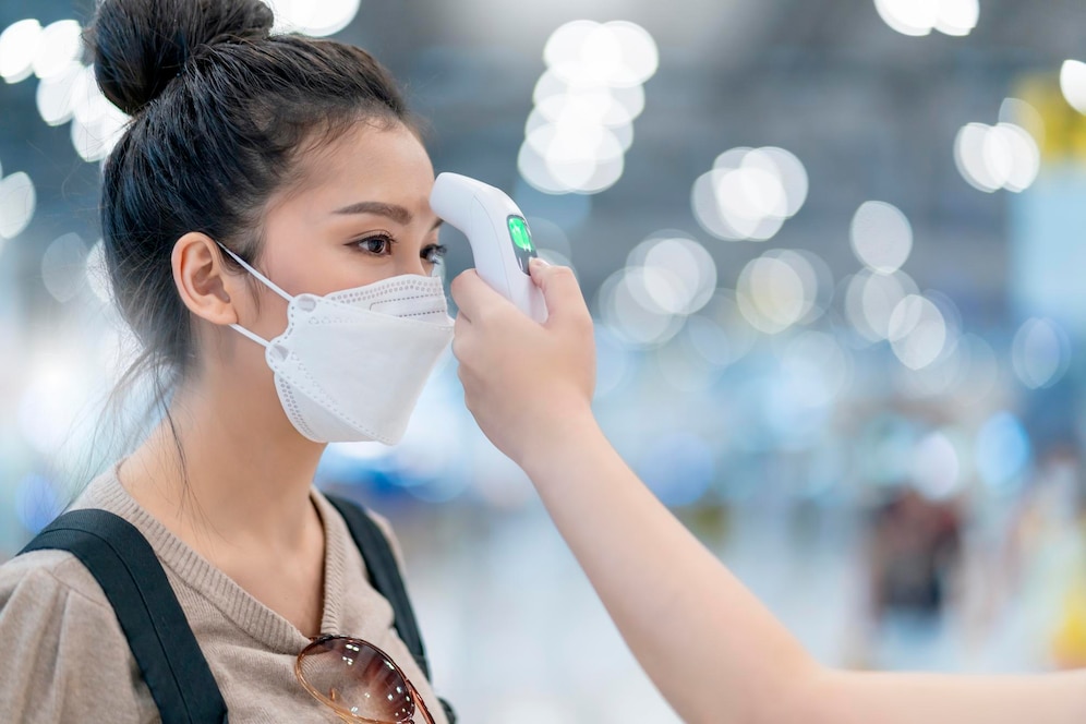 terminal-staff-check-asian-woman-body-temperature-with-infrared-forehead-thermometer-thermometer-gun-virus-symptom-checking-corona-virus-covid19-quarantine-virus-outbreak-travel-concept 609648-496