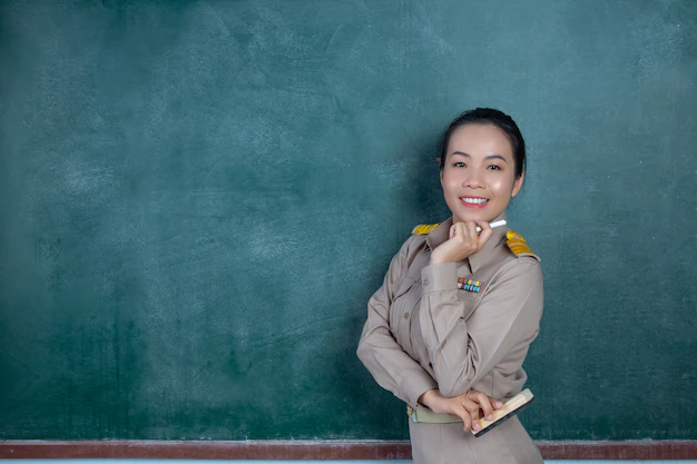 happy-thai-teacher-official-outfit-posing-front-blackboard 1150-20604