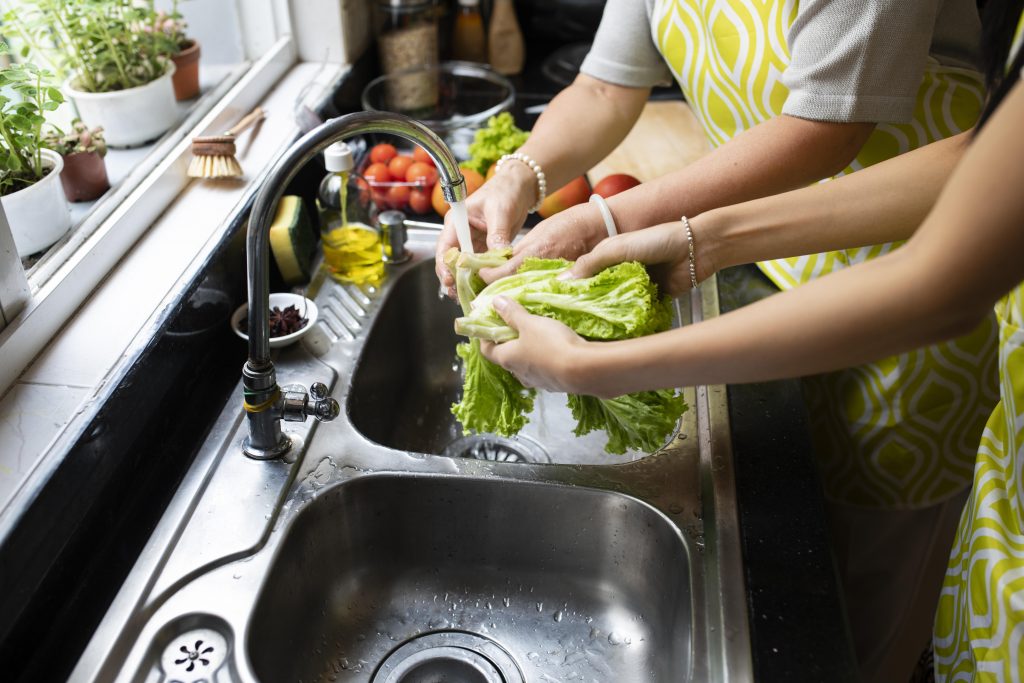 close-up-hands-washing-vegetables