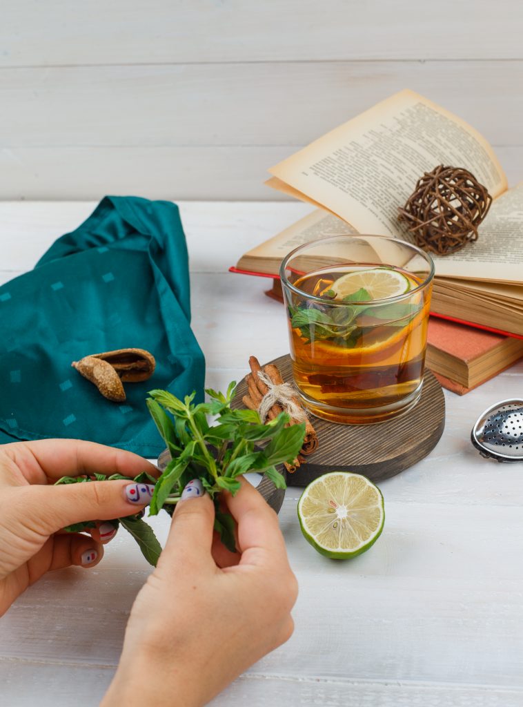set-books-lemon-mint-green-scarf-herbal-tea-cinnamon-wooden-board