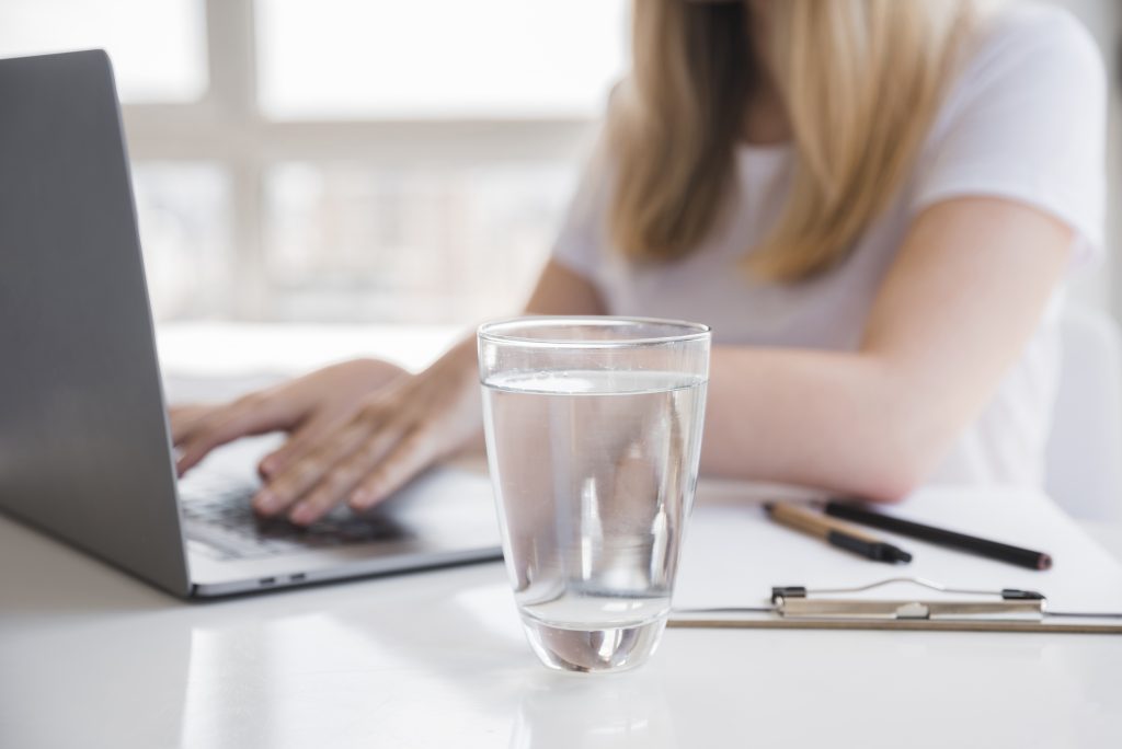 healthy-girl-using-laptop-with-glass-water-1