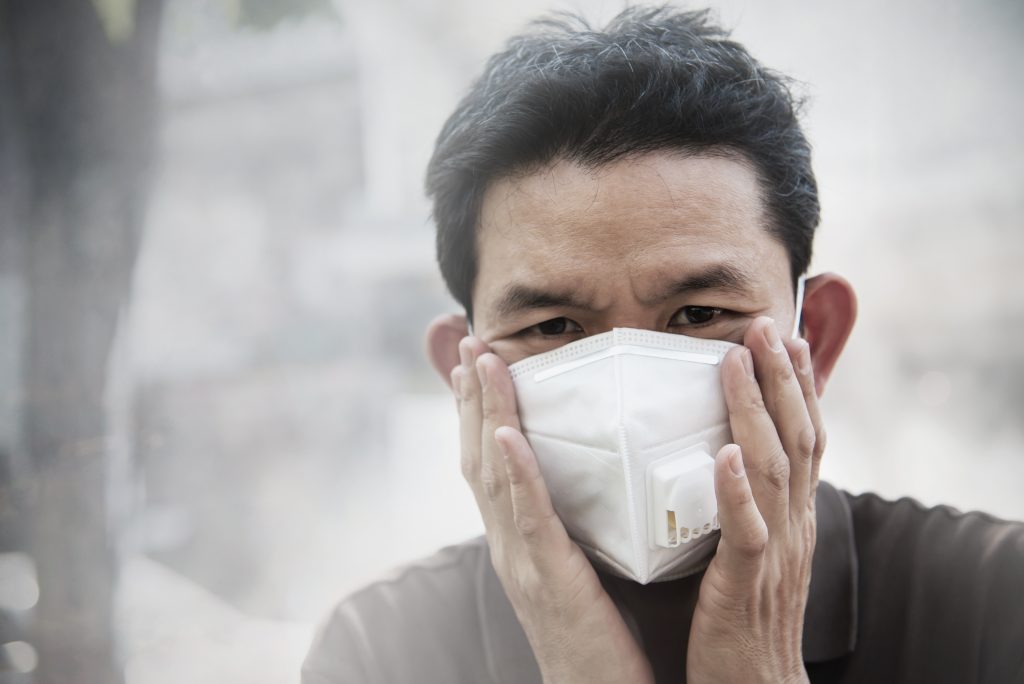 man-wearing-mask-protect-fine-dust-air-pollution-environment