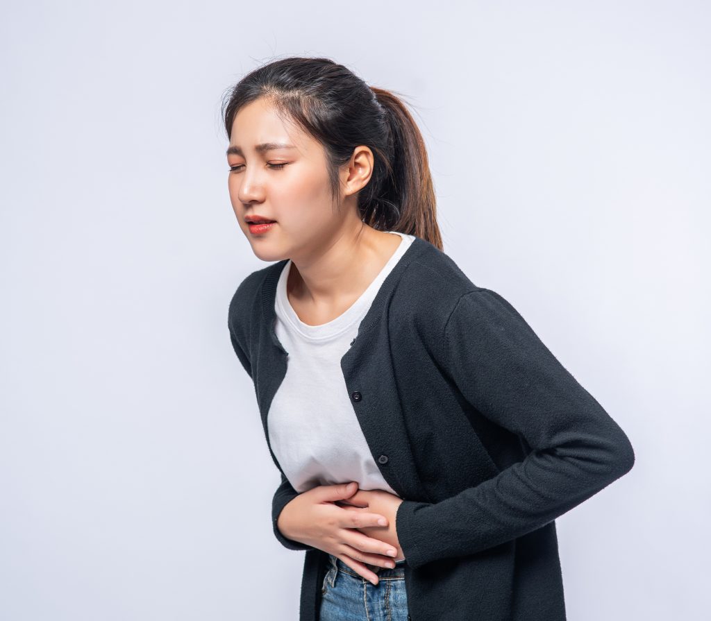 woman-standing-with-stomach-ache-presses-her-hand-her-stomach-1