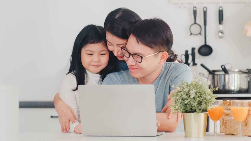 young-asian-family-enjoy-using-laptop-together-home-lifestyle-young-husband-wife-daughter-happy-hug-play-after-have-breakfast-modern-kitchen-house-morning