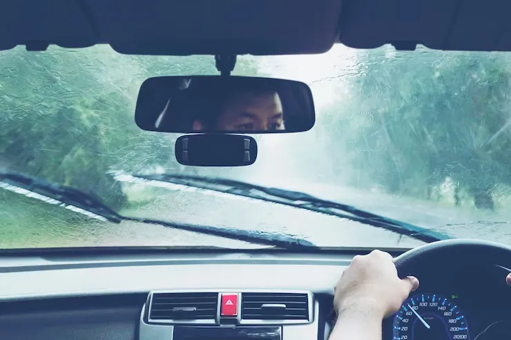 man-driving-car-heavy-rainfall 1