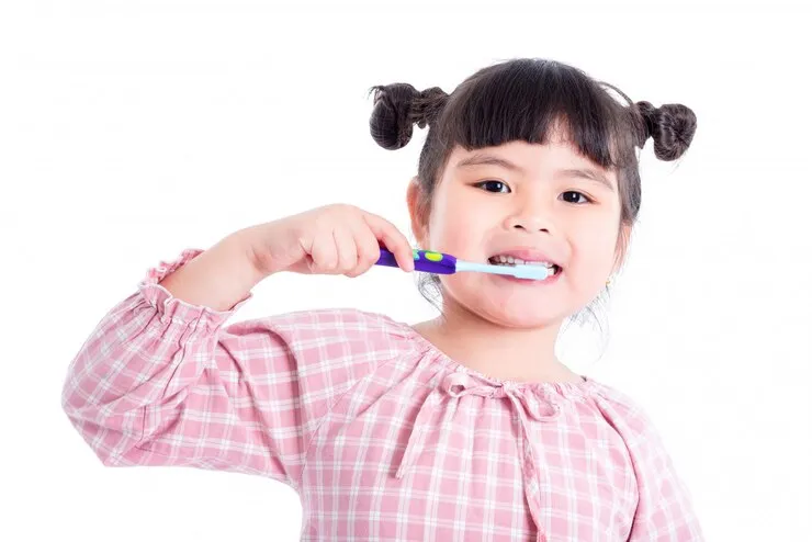 little-asian-girl-holding-toothb