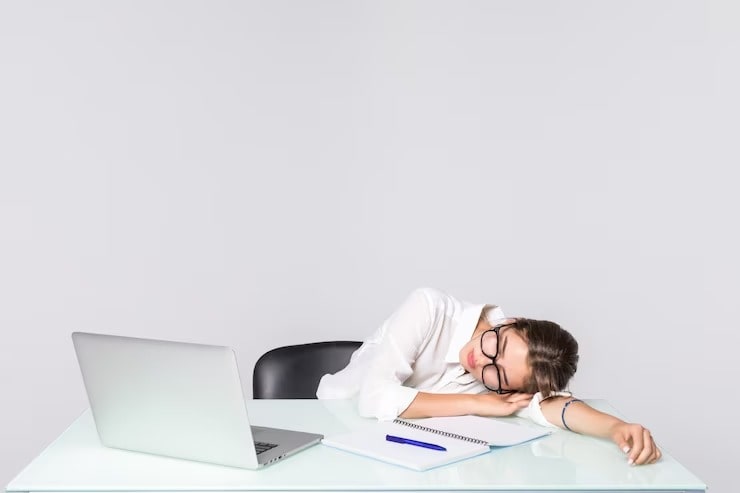 businesswoman-asleep-her-desk-is-min