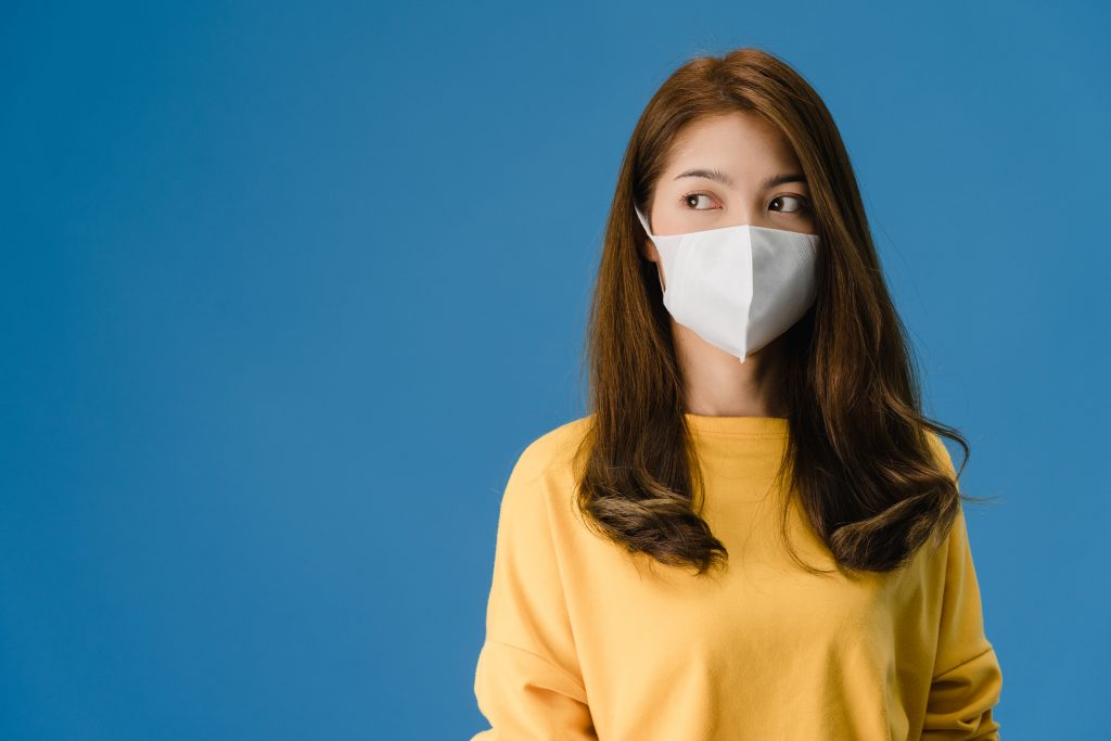 Young Asia girl wearing medical face mask with dressed in casual